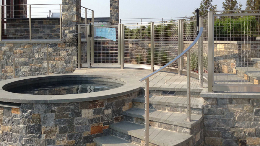Mesh panel handrail baluster paired with stair cable railing by AGS Stainless