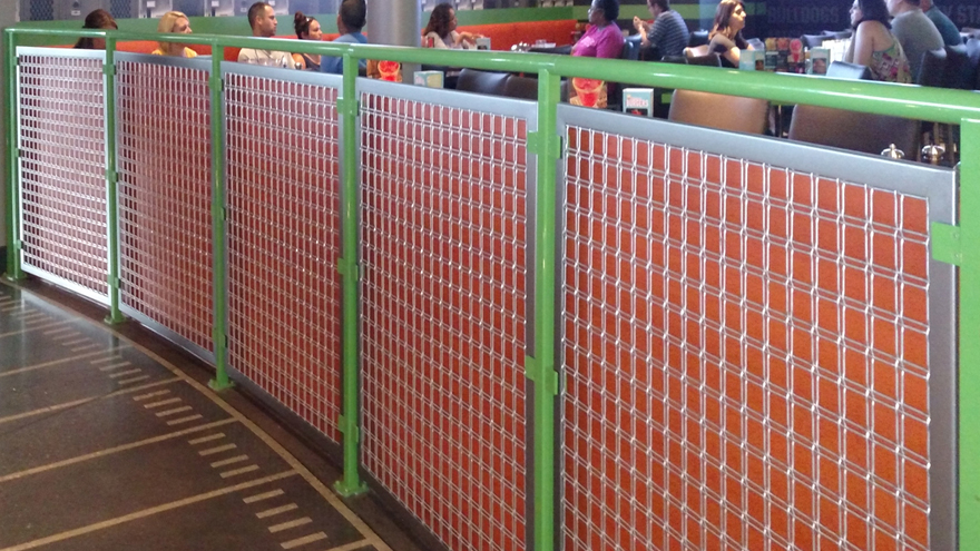 Unique railing system with green powder coat railing posts and wire mesh panel railing infill.