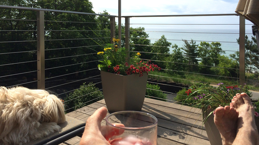 relaxing on a waterfront deck with beautiful cable railing.