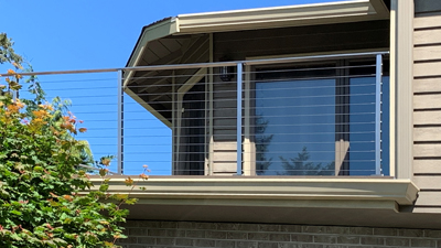 This distinctive design combines two modern railing ideas: stainless cable rail and glass panel railing.