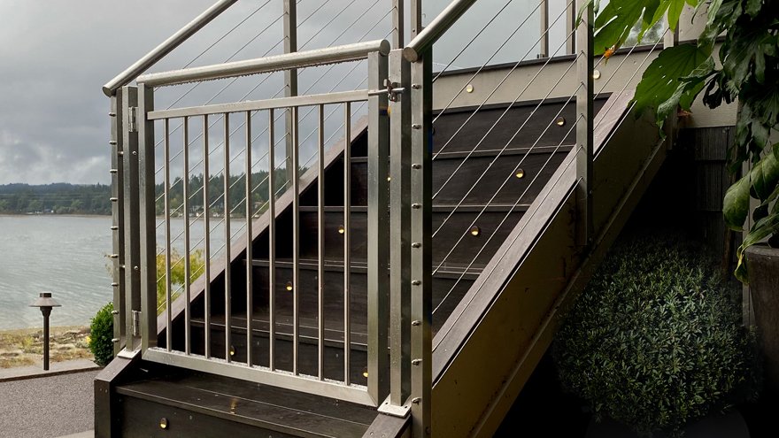 custom fabricated cable gate at the entrance to a set of stairs
