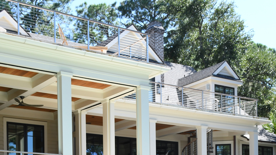 A custom-built luxury home showcases Rainier cable railing. The front porch cable rail, back porch railing, balcony handrail, deck railing system, & handrail for stairs are by AGS Stainless.