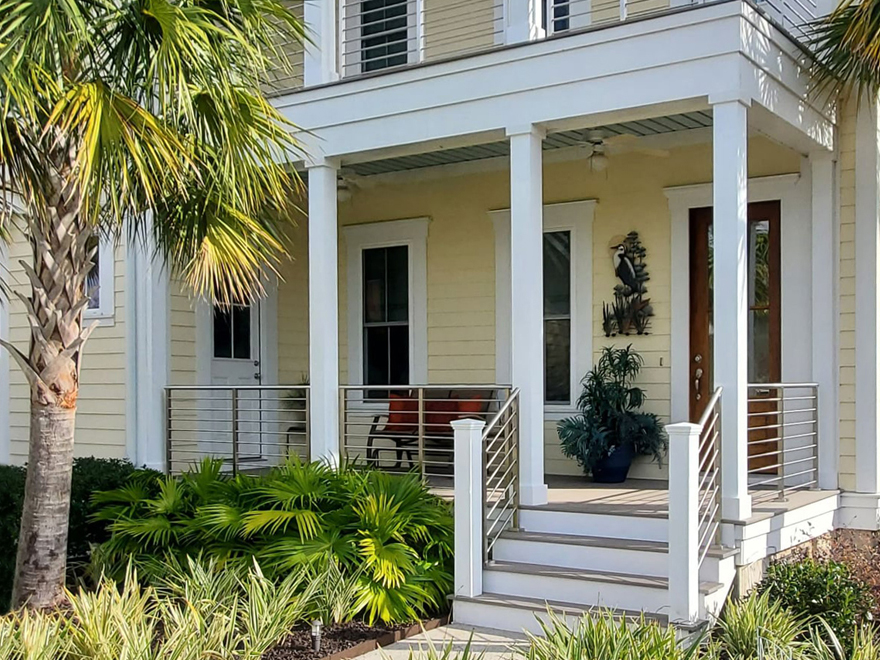 stainless tube handrail on porch. The stainless horizontal handrail with wood newel look smart in this SC neighborhood.