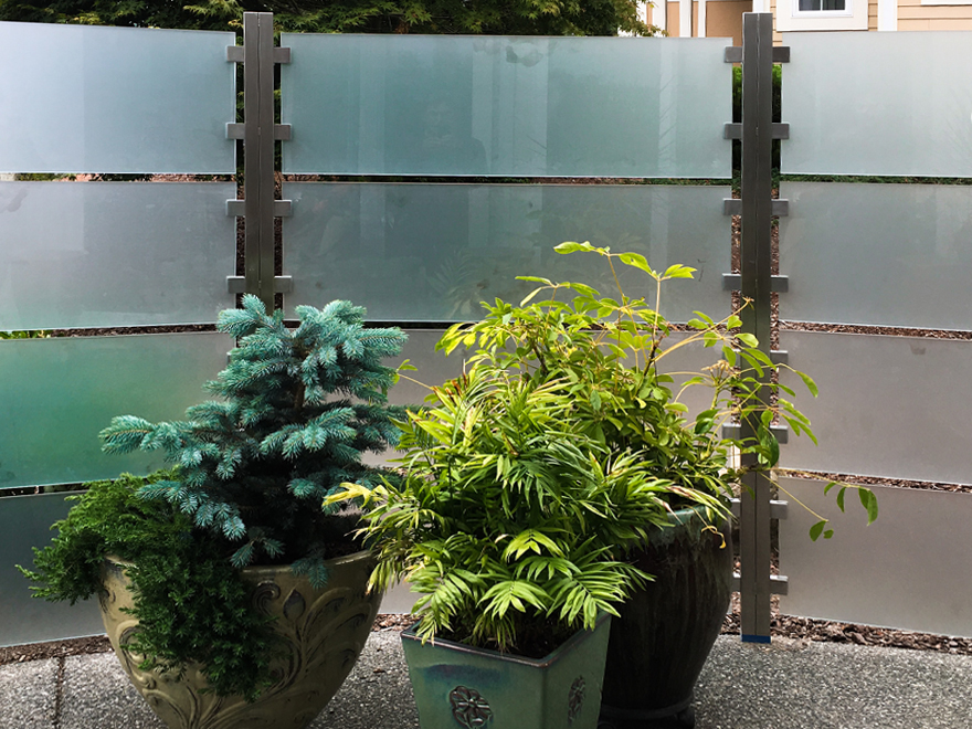 A glass porch railing design may utilize frosted glass panels to enhance privacy.