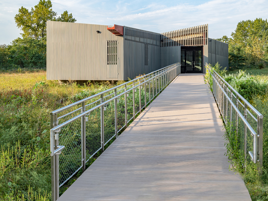 Commercial glass railing has mesh panel infill. A stainless glass railing if custom-built, is exceptionally versatile.
